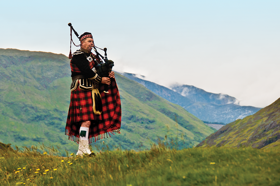 Lone Bagpiper in the Scottish Highlands